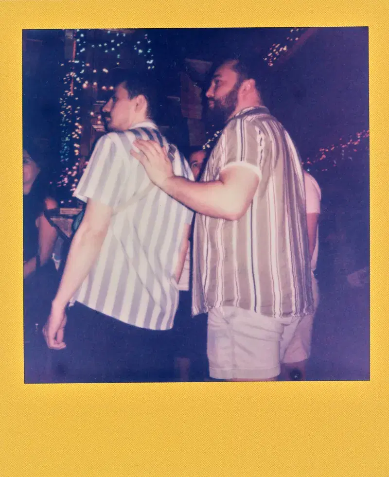 Polaroid of people standing inside a bar
