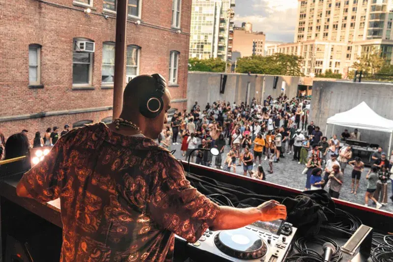 a dj playing music in front of a crowd of people.