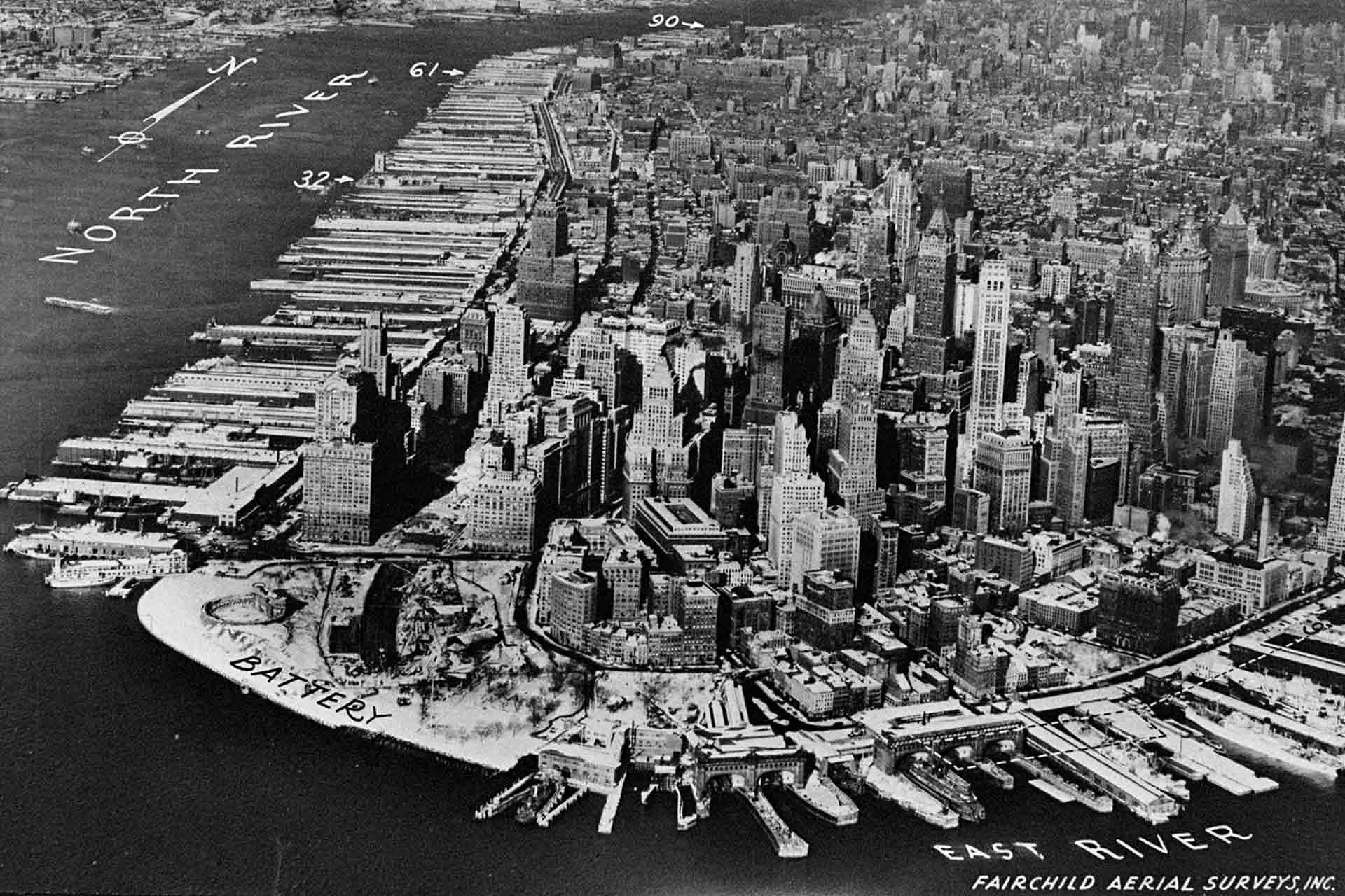 An archival aerial view of Manhattan, New York City, showcasing densely packed skyscrapers.