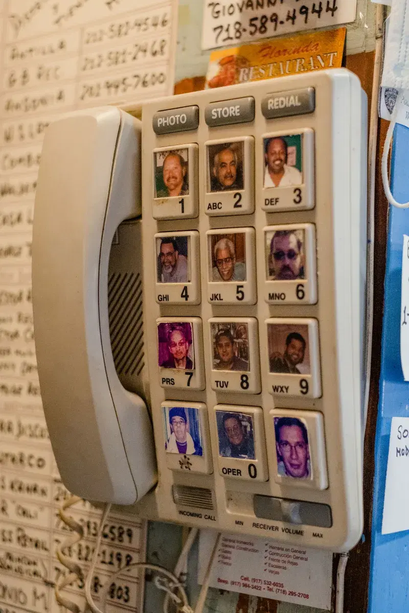 Phone on wall with photos on the buttons, in Casa Amadeo in The Bronx