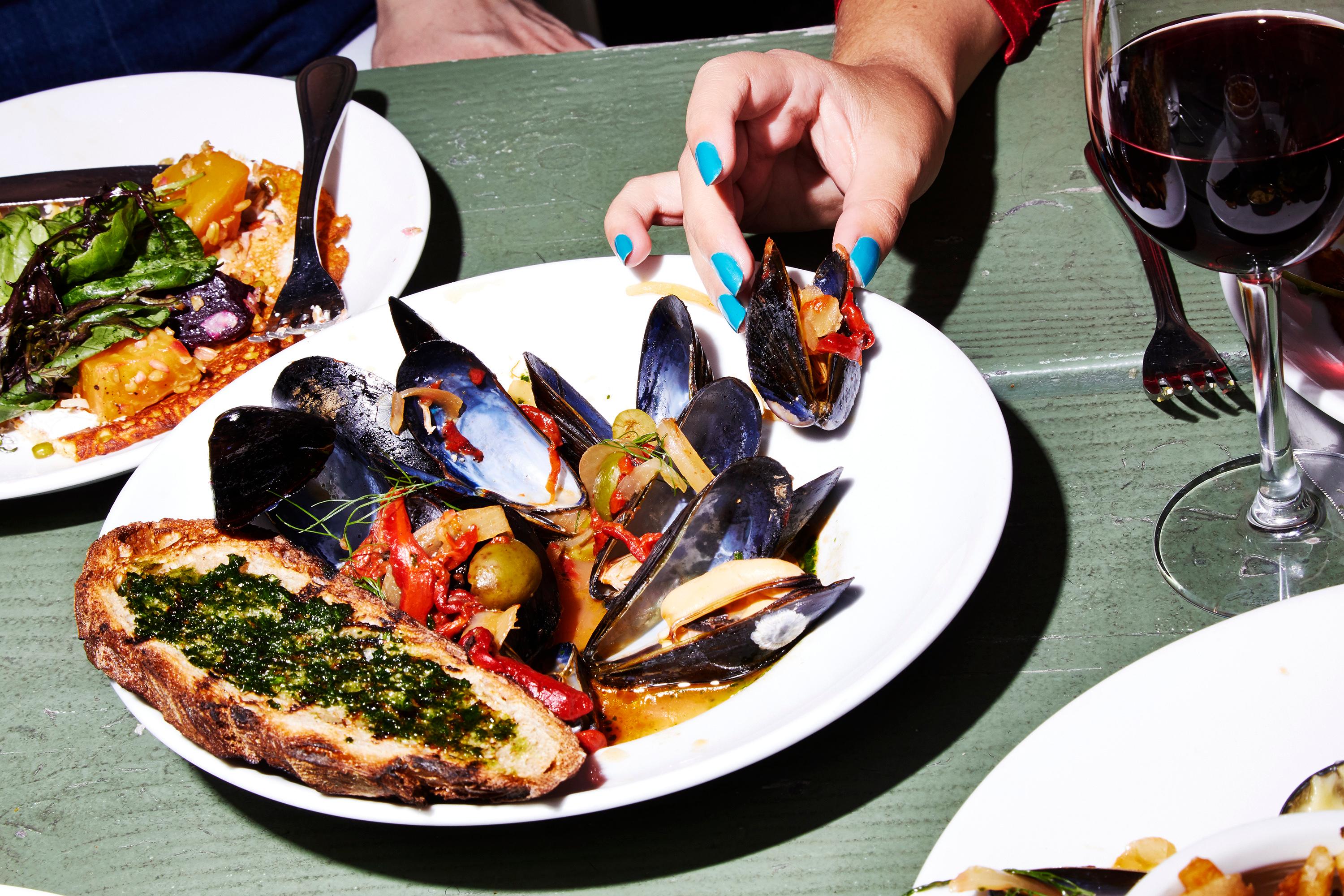 Person eating Oysters, close up of their hand