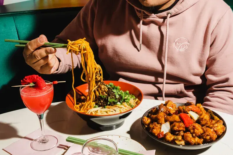 image of person eating vegan szechuan food