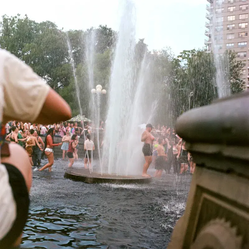 People inside the fountain at Washington Square Park