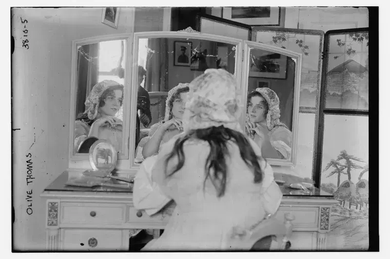 Archival image of Olive Thomas looking in Mirror