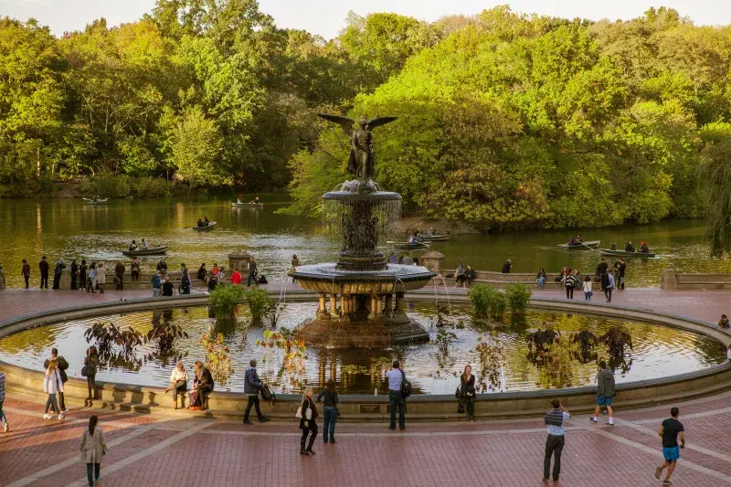 People walk around Bethesda Fountain in Central Park in Manhattan
