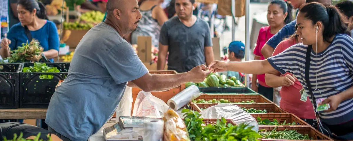 People buying fruits and vegetables at Corona Farmers Market