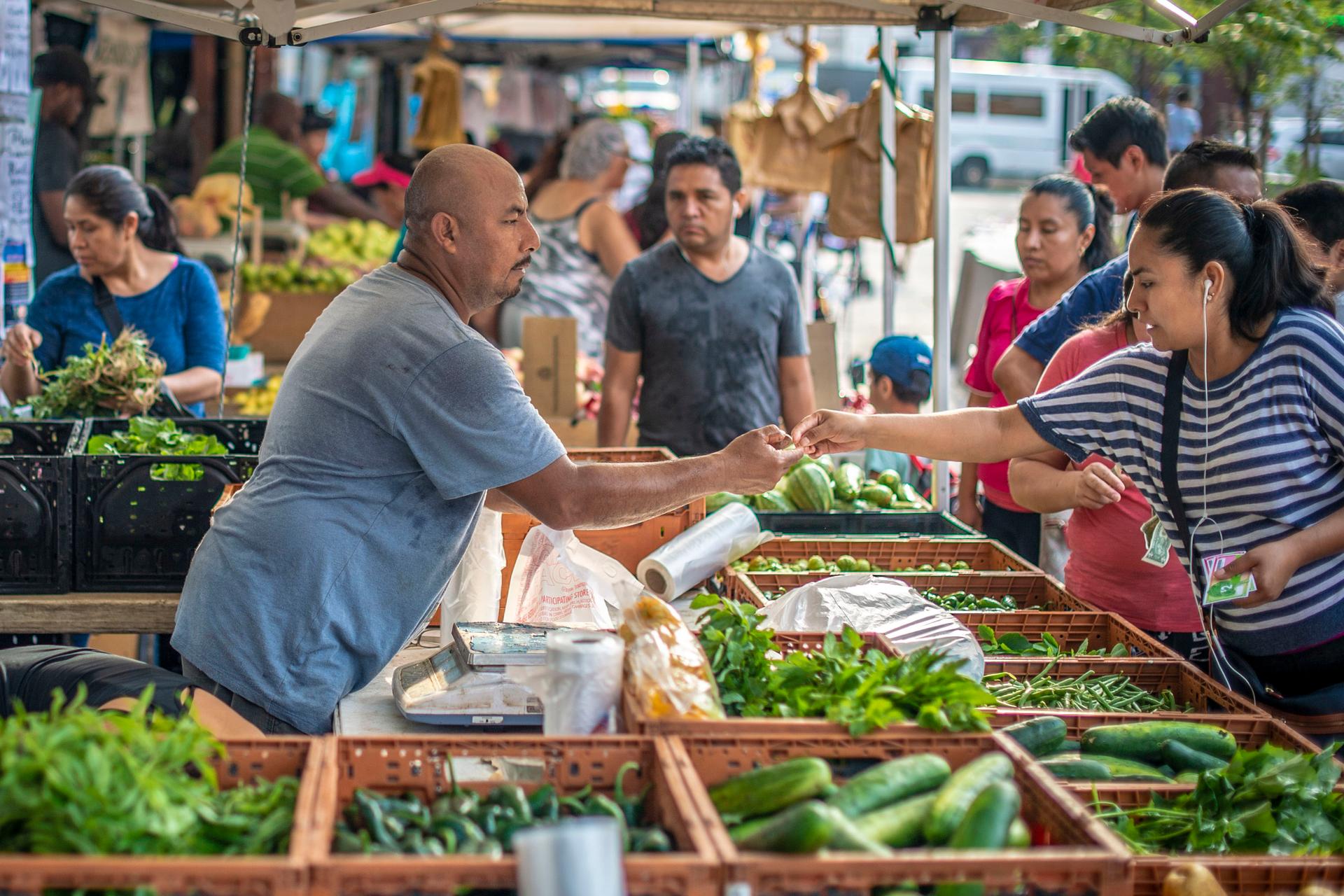 People buying fruits and vegetables at Corona Farmers Market