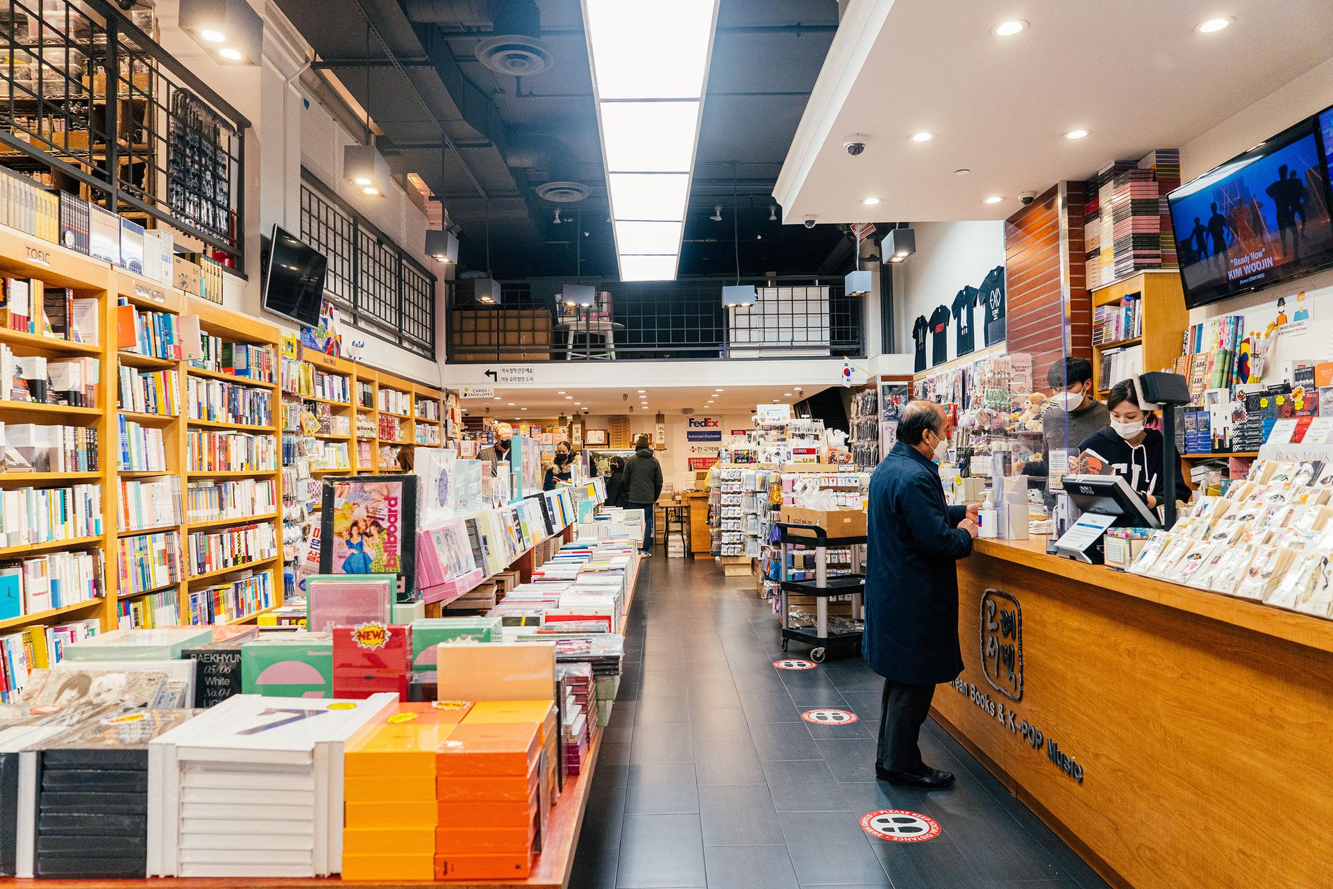 A person buying a book, at Koryo Books, interior image, in Manhattan