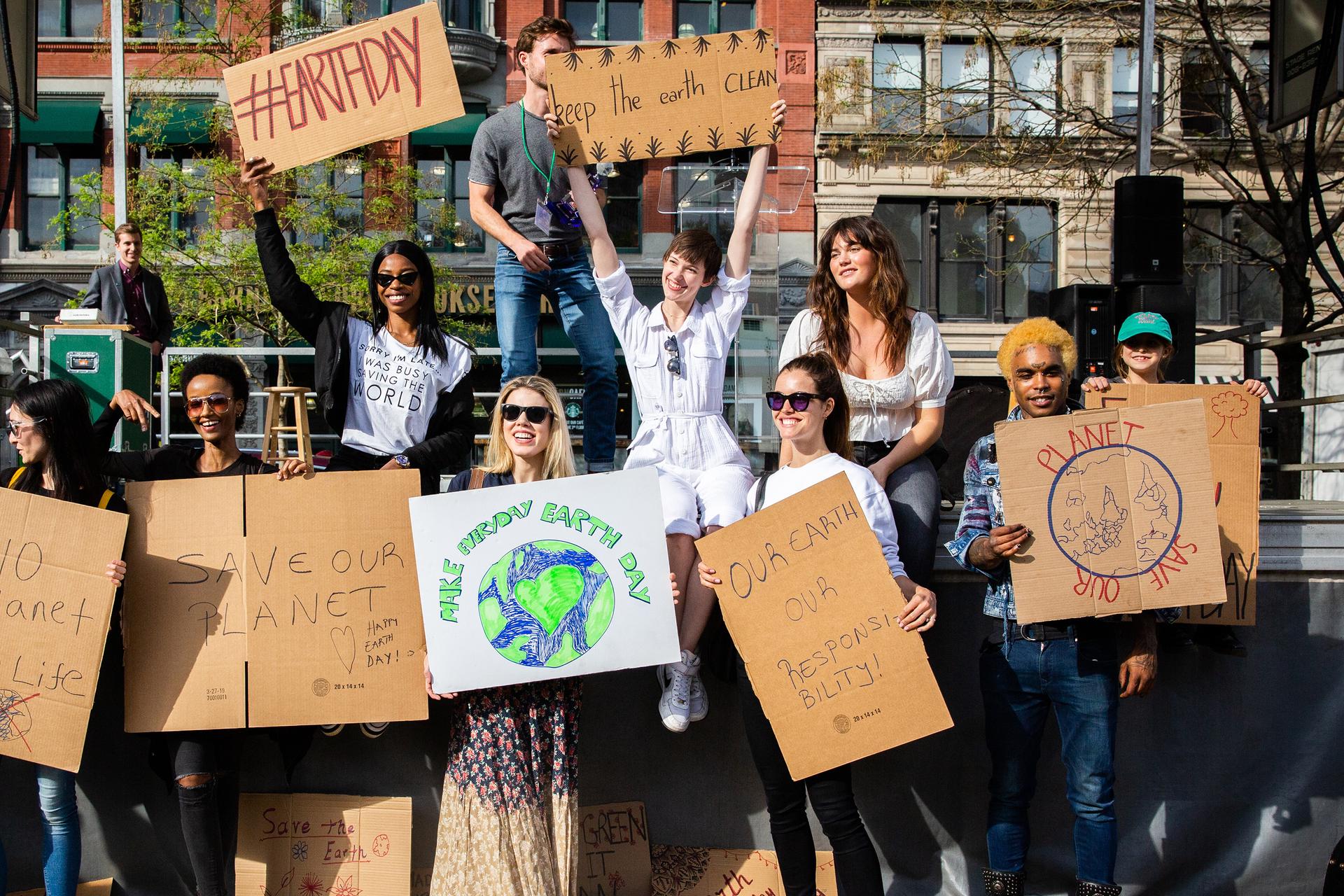 People carry signs during Earth Day, event in Manhattan, New York City 