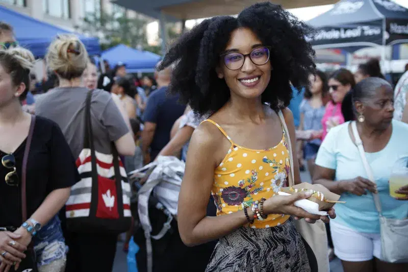 A person poses for the camera at Bronx Night Market