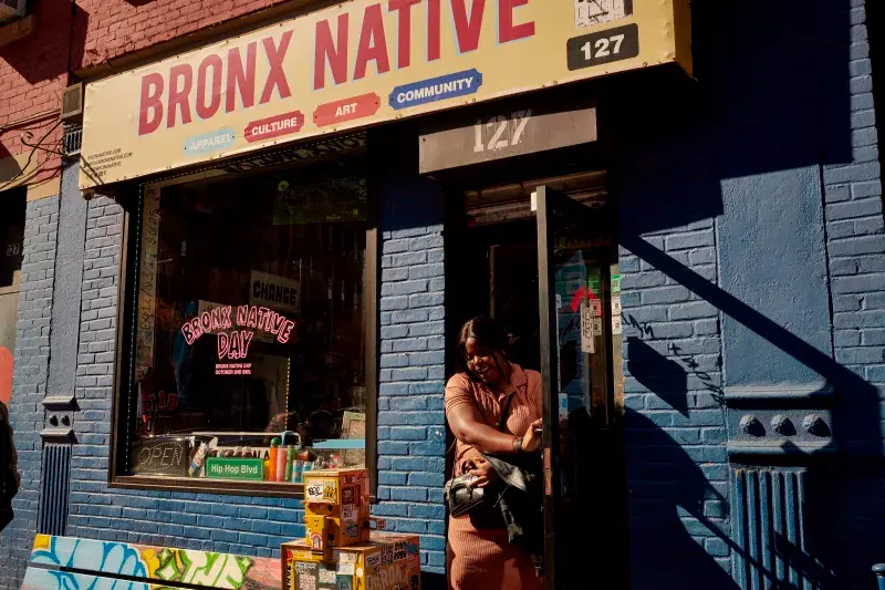 person walking out of Bronx native shop, in the Bronx