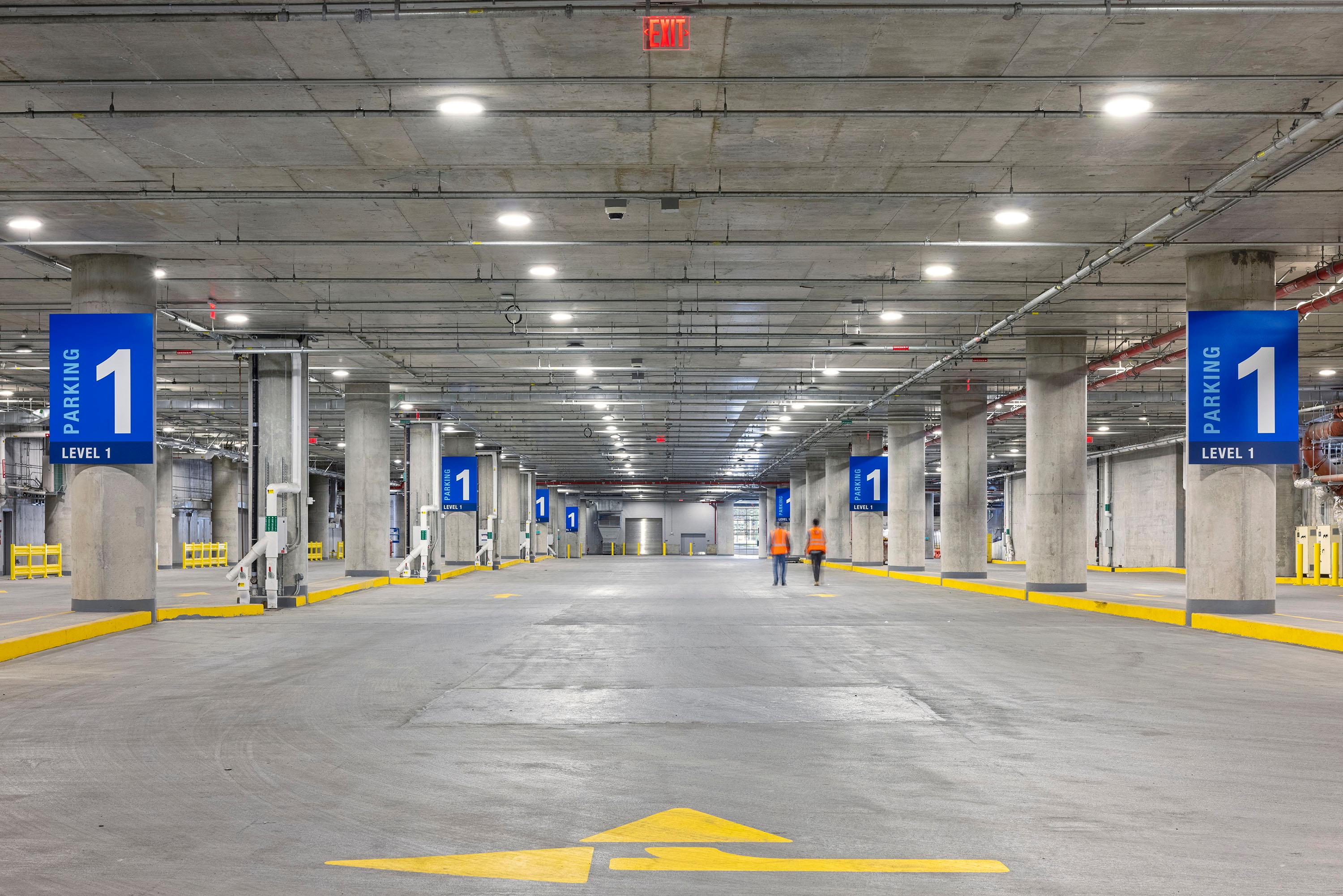 Two people walk at a parking lot