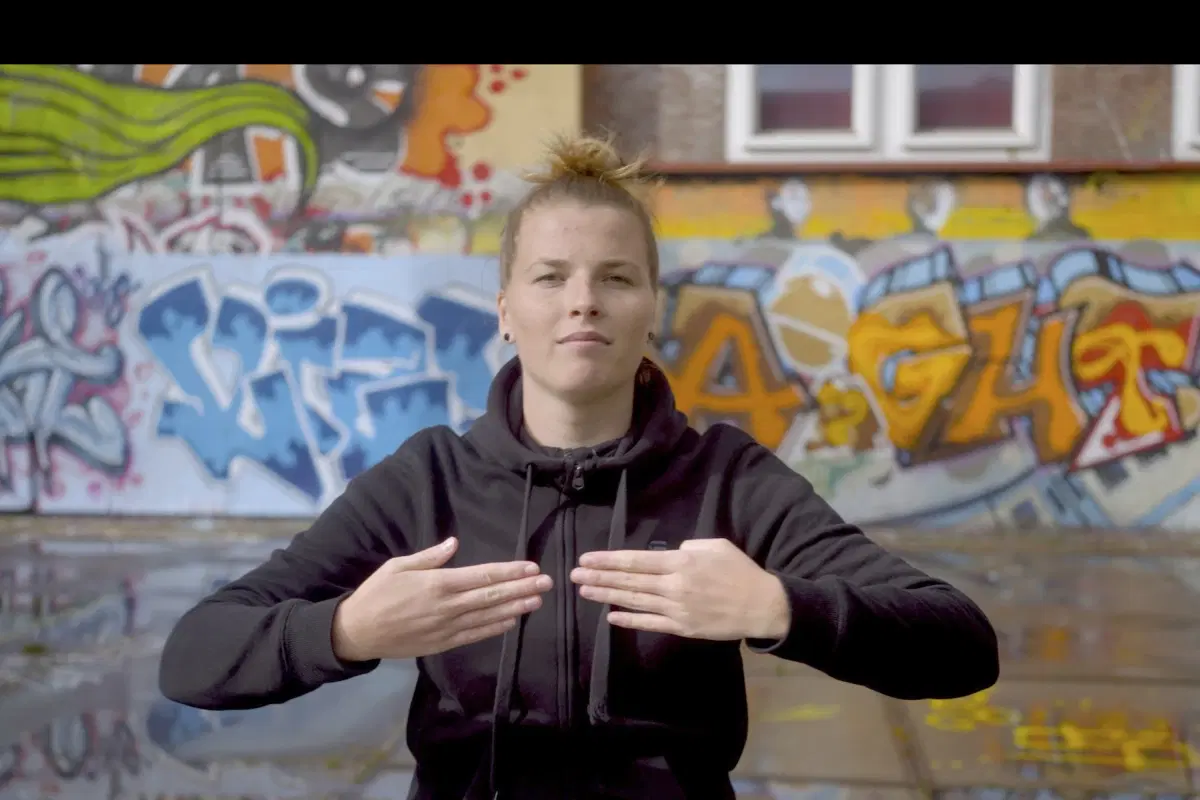 Still image of person holding hands facing the camera from the short film Imagining