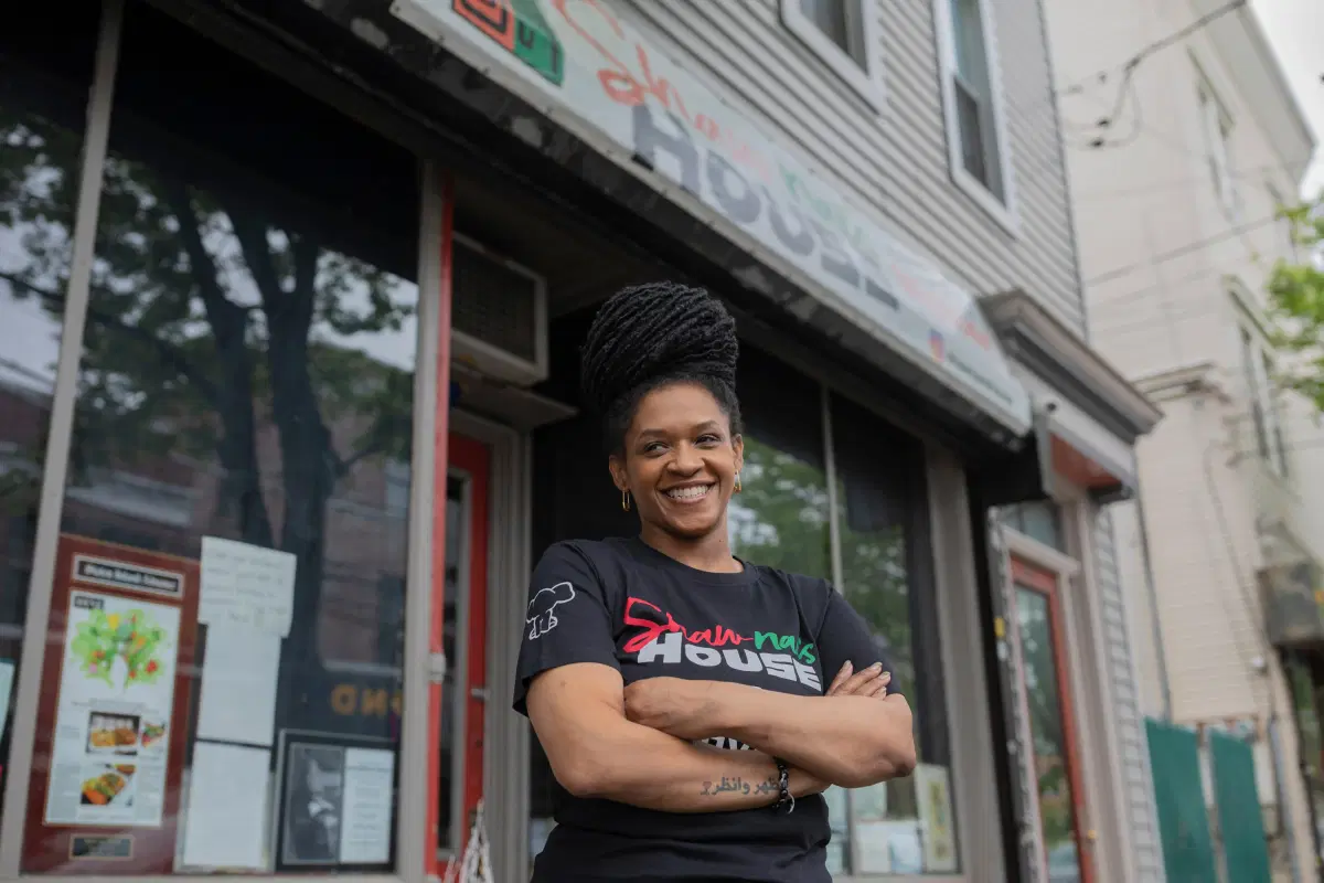 Shaw-naé Dixon standing outside her restaurant, Shaw-naé’s House