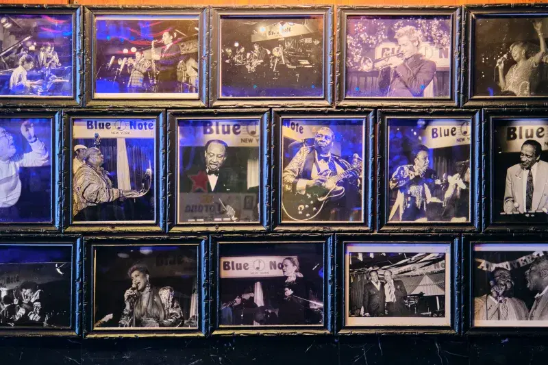 a group of framed photos of jazz musicians.