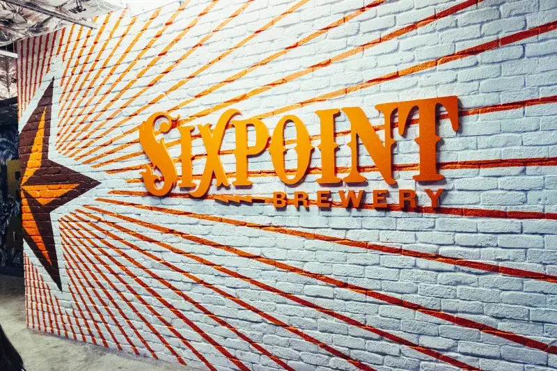 Wall with sixpoint brewery logo