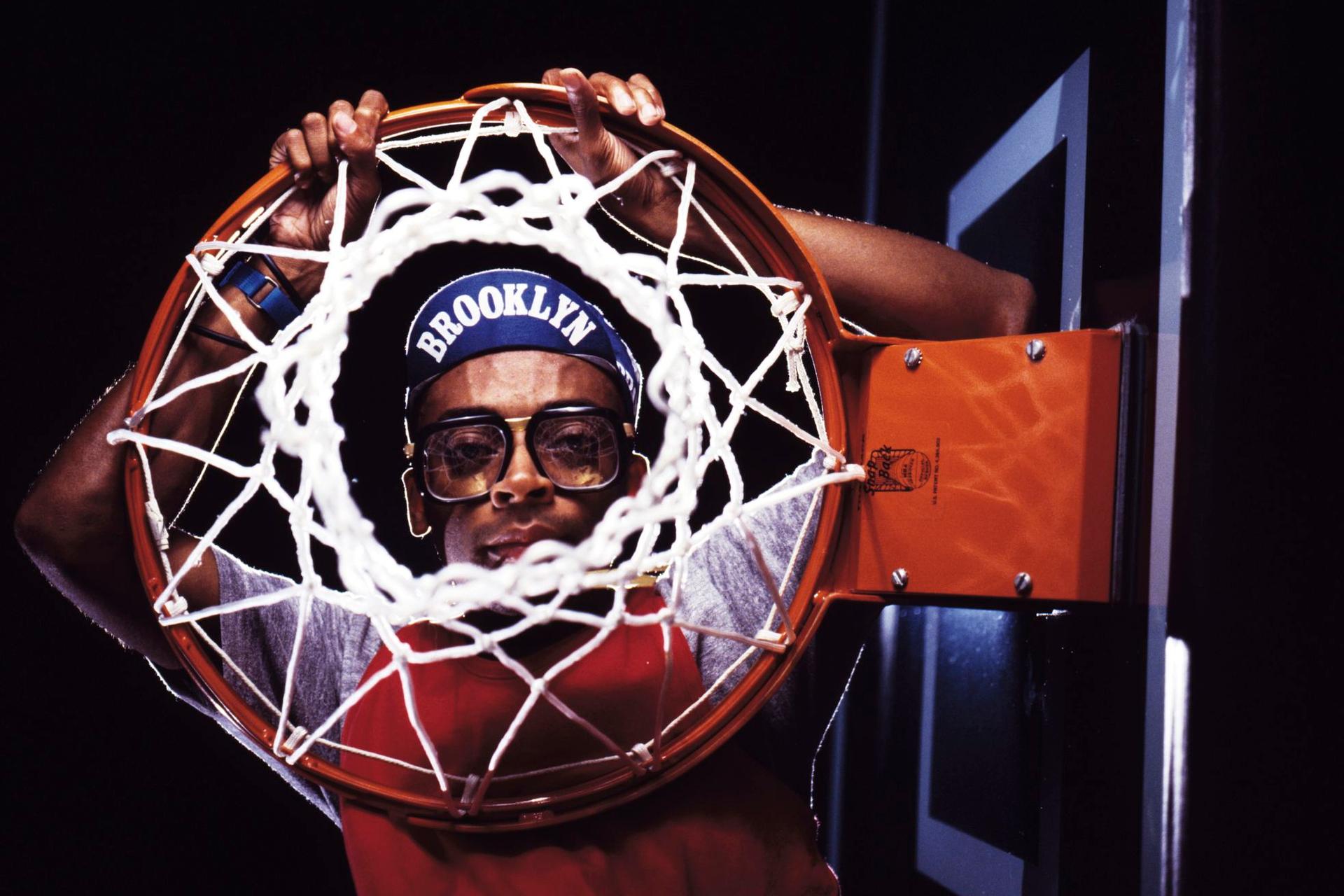 Portrait of Spike Lee with basketball net