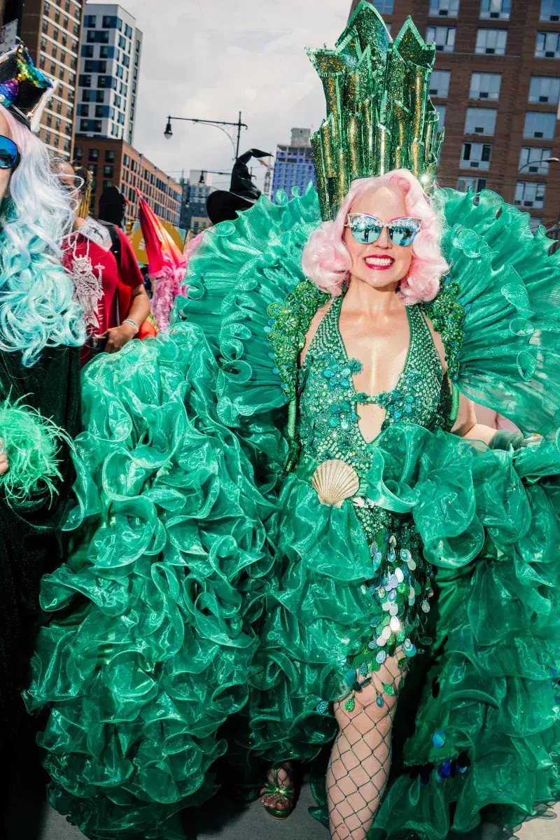 Person in green costume at Mermaid Parade