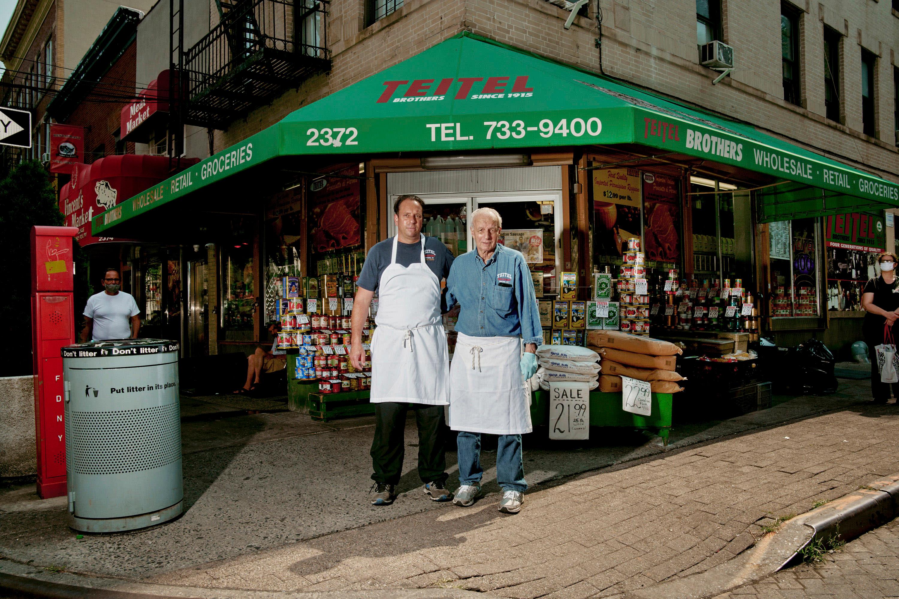 Two people standing in front of Teitel Brothers in the Bronx