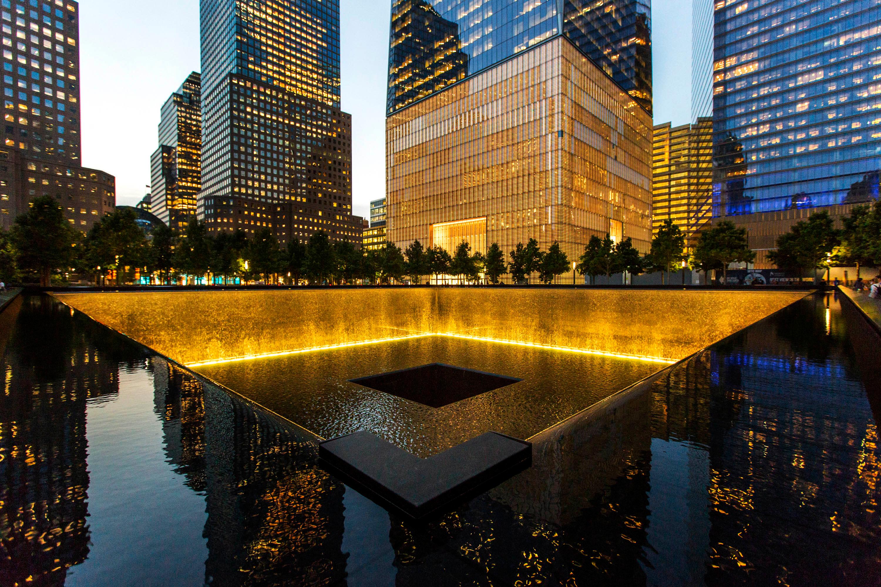 The National September 11 Memorial illuminated at dusk, in Lower Manhattan